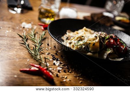 Black Angus pappardelle pasta with beef, champignon and parmegano cheese