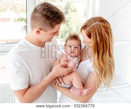 Young couple with beautiful baby at home
