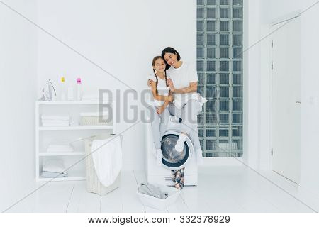 Happy Mother And Daughter Have Fun, Embrace And Express Love To Each Other, Dressed In Casual Wear, 