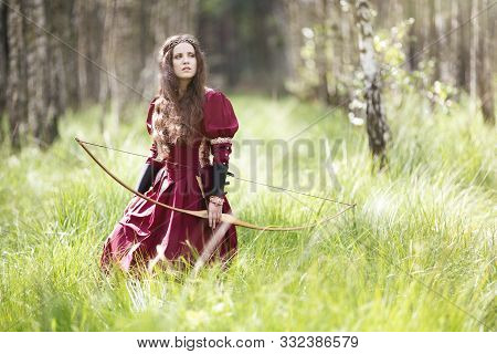 An Elf Archer With A Bow In The Woods