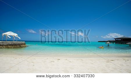 Maldives White Sand Beach With Turquoise Water And Blue Sky