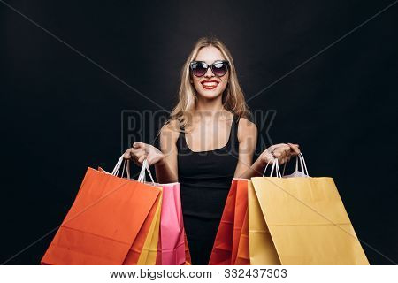 Cute Model Girl Demonstrating A Bunch Of Paper Bags