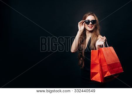 Cute Female Boutique Customer With Bags Of Fashionable Purchases