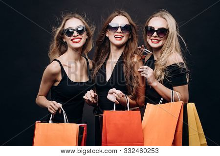 Stylish Chic Model Female Customers With Paper Bags
