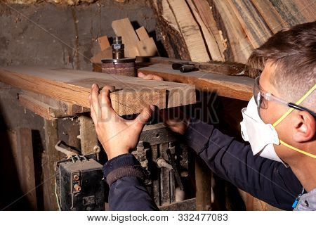 Wood Worker Selects Flat Boards For The Manufacture Of Wood Products,carpenter Artisan Checks The Qu