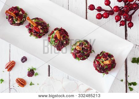 Holiday Cheese Ball Appetizers With Cranberries, Pecans And Herbs. Top View On A Serving Plate With 