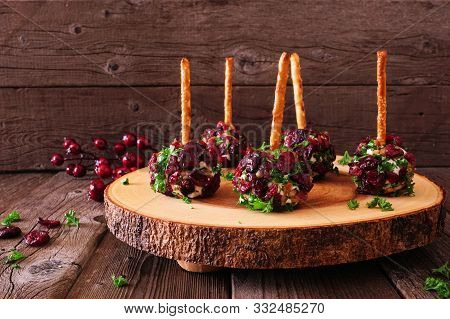 Holiday Cheese Ball Appetizers With Cranberries, Pecans And Herbs On A Rustic Wood Platter Against A