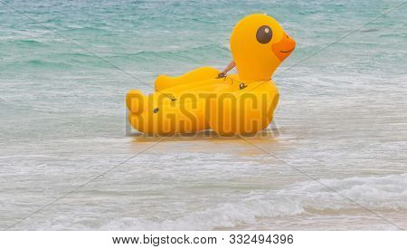 Yellow Rubber Duck Floating In The Sea