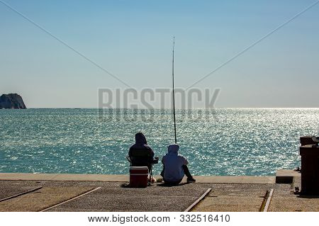 Unknown Husband And Wife Spending The Day Fishing Off The Tolaga Bay Wharf