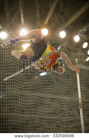 Pole Vaulting - Man Is Jumping Over The Bar And Is Going To Let Go Of The Pole
