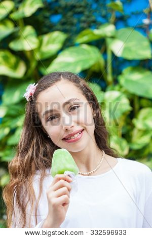 Young Girl Eating A Traditional Water Ice Cream Typical Of The Valle Del Cauca Region In Colombia