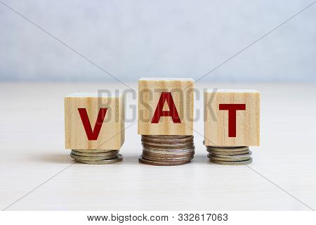Vat On Wooden Cubes Over Blue Background, Financial Concept Background
