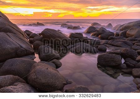 panorama sunset at Laem Sai cape. Many small and large stones surround Laem Sai cape from Karon Beac