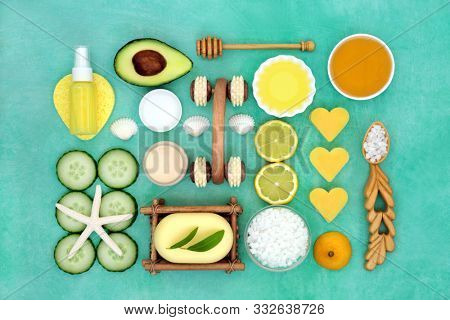 Beauty treatment for skincare with avocado, lemon and cucumber with spa, exfoliation, moisturising and  cleansing products. Flat lay.