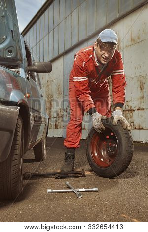 Cute Man In Red Overall Tunning His Lovely Retro Car