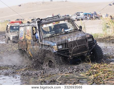 Almaty, Kazakhstan - September 29, 2019: Off-road Jeep Competition. Dirt And Splash Of Water In Off-