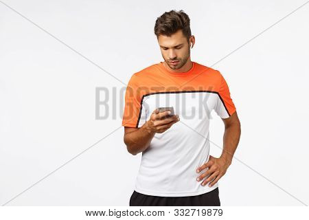 Attractive Young Male Athlete In Sports T-shirt, Running, Prepare For Maraphon, Wear Wireless Earbud