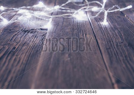 Glowing Bokeh Background With Empty Wooden Table. Christmas Background