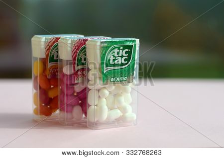 Many Tic Tac Candy Packages On Green Wood Background. Tic Tac Is Popular Due Its Minty Fresh Taste A