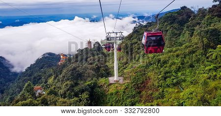 Cable Car At Genting Highlands, Malaysia In A Foggy Weather With Green Grass Visible From Inside Cab