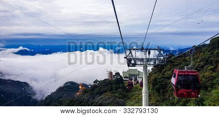 Cable Car At Genting Highlands, Malaysia In A Foggy Weather With Green Grass Visible From Inside Cab