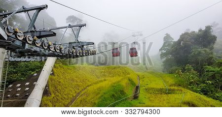 Cable Car At Genting Highlands, Malaysia In A Foggy Weather With Green Grass Visible From Inside Cab