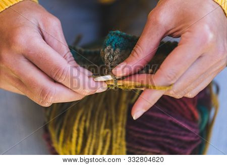 Female Hands Close-up. Young Woman Is Knitting. Knitting Needles And Threads. Multi-colored Yarn. Ha