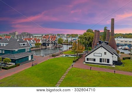 Aerial from traditional brick factory and houses in Huizen the Netherlands at sunset