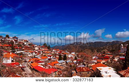 Pedoulas Village On Cyprus In Troodos Mountains With Blue Sky And Copy Space. Panoramic View.