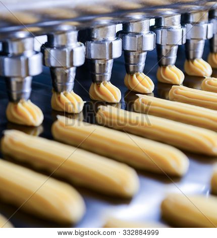 Cakes On Automatic Conveyor Belt Or Line, Process Of Baking In Confectionery Culinary Factory Or Pla