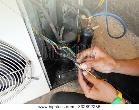 Technician Repairing Outdoor Air Conditioner Unit ,cabal Burn Because Short Circuit.