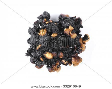 Burnt popcorn kernel isolated over white background