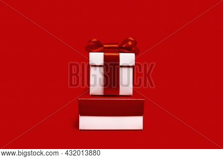One White Gift Box With Reb Bow On Red Background