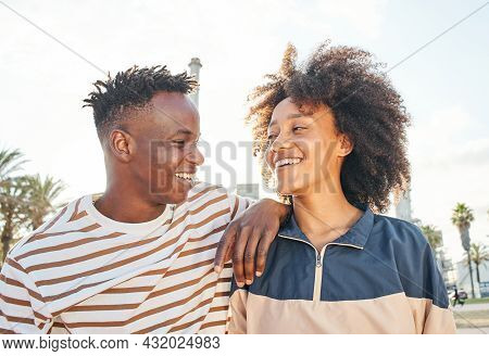 Portrait Medium Shot Of A Young Black Couple Looking At Each Other Smiling. Concept Of Family, Broth