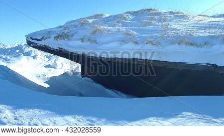 Close-up Of Frozen Rusty Ship Full Of Snow. Frozen And Abandoned Ship In The Arctic Close-up