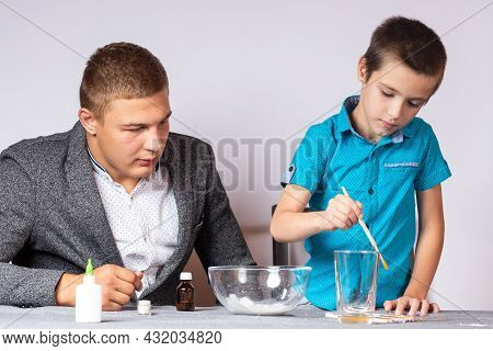 Chemistry Education And Training Concept. Close-up Of A Boy And His Dad Doing A Home Chemical Experi