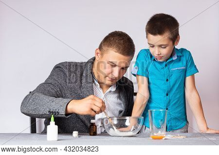 Chemistry Education And Training Concept. Close-up Of A Boy And His Dad Doing A Home Chemical Experi
