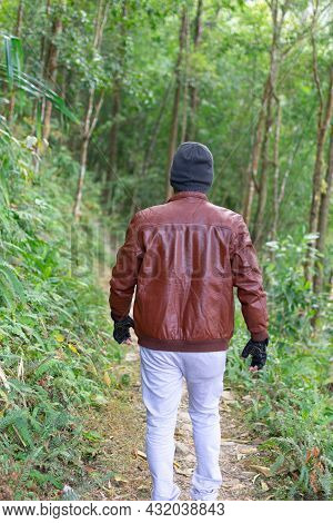Young Indian Man Adventures In The Deep Forest. Man Walking In The Woods In Darjeeling, India.