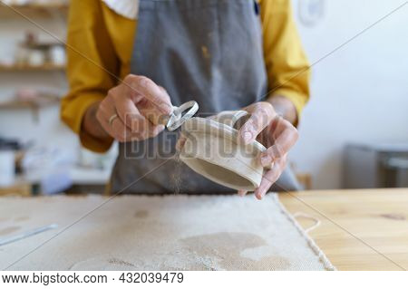 Working With Raw Clay: Caucasian Female Ceramic Studio Owner Shaping And Modeling Material For Prepa