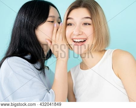 Friendly Gossip. Happy Women. Secret Whisper. Ethnic Diversity. Conspirator Asian Lady Sharing Funny