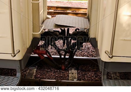 Close Up Detail Of Iron Connection Of Two Train Wagons. Railway Car Coupler And Train Buffers. Buffe