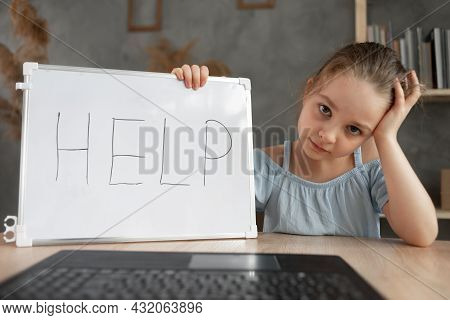 A Sad Girl Sits At A Computer Laptop, Suffering From Cyberbullying And Harassment, Subjected To Onli