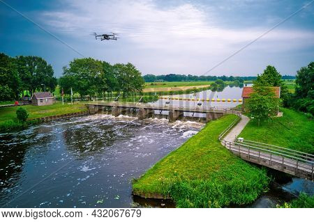 Water Swirls From The Weir In The River Vecht In The Netherlands. Downstream, Lock Keepers House Nex