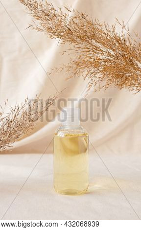 Hydrophilic Cleanser Oil On Linen Drapery And Dry Plant. Makeup Remover Cosmetic Beauty Skincare Pro
