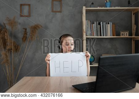 A Sad Girl Sits At A Computer Laptop, Suffering From Cyberbullying And Harassment, Subjected To Onli