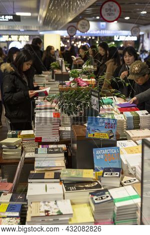 People Are Choosing Books From An Asian Store. Vertical. Seoul, South Korea, 12-30-2017.