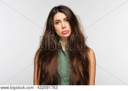 Sad Young Woman With Problematic Tangled Long Hair Isolated On Grey