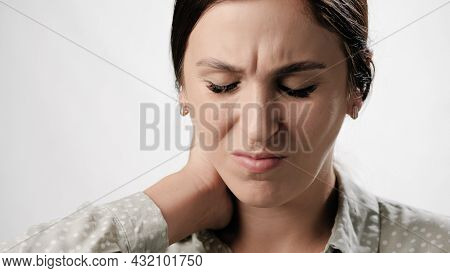 Pain In Neck, Neckache. Suffering Woman With Neckache On White Background. Close-up