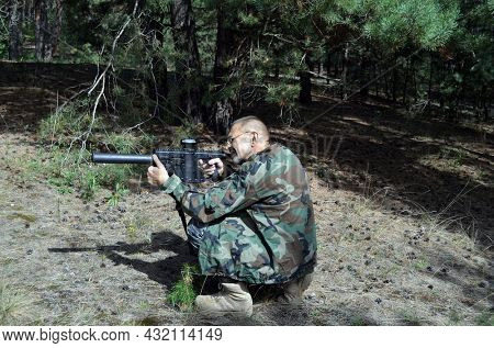 Mature man with KRISS Vector 9*21 caliber submachine gun in the forest. Unformal shooting range near Kiev. September 6,2021. Kiev Region, Ukraine