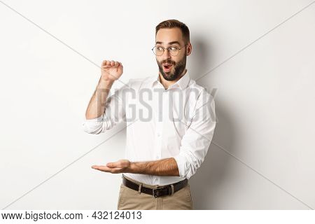 Amazed Businessman Showing Big Object, Describe Something Large And Looking Excited, Standing Over W